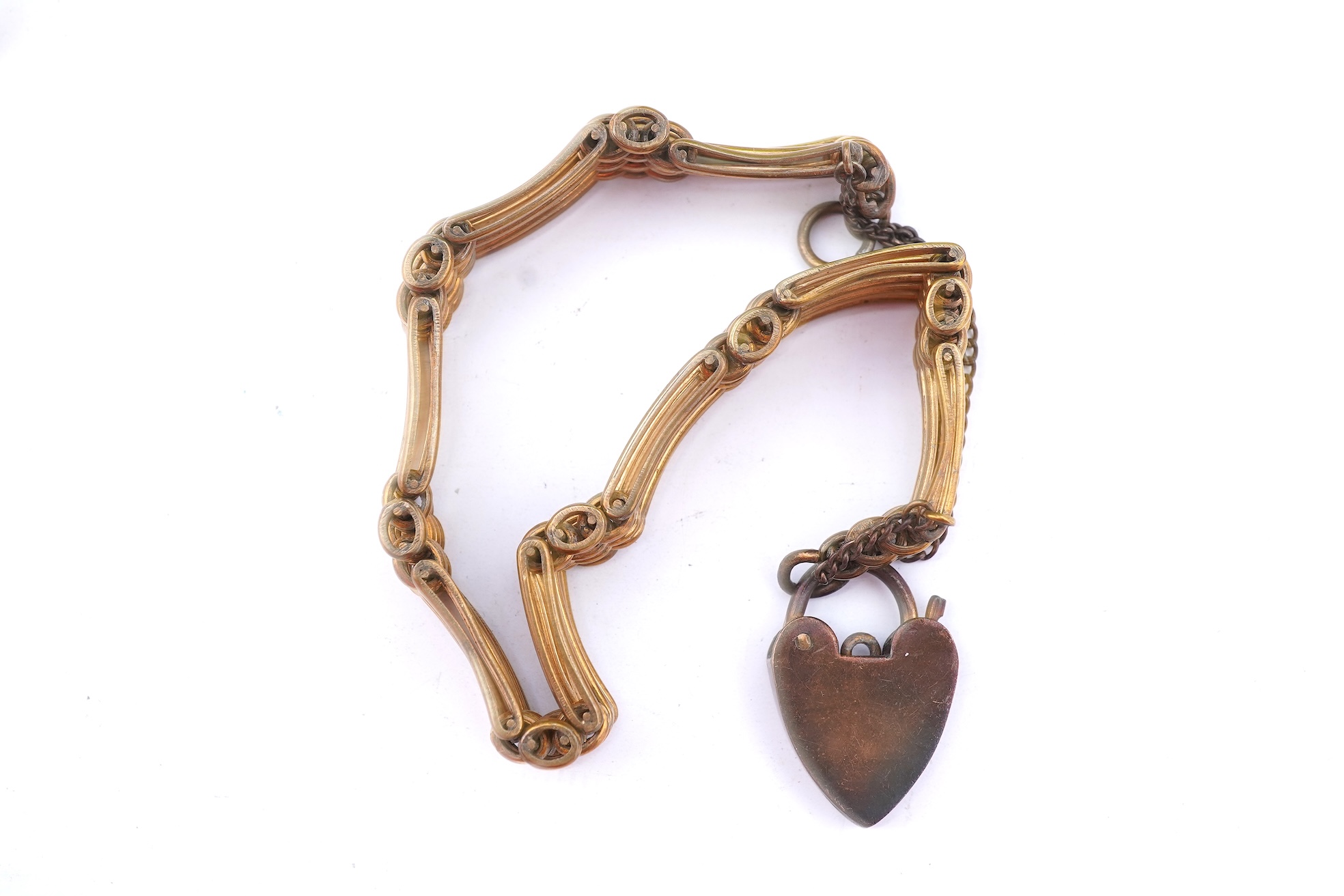 A group of gilt metal/pinchbeck jewels, 19th and early 20th century, comprising: a brooch of knotted design; two gate bracelets; a fancy link bracelet; an open-faced pocket watch; two oval panel brooches, and two watch c